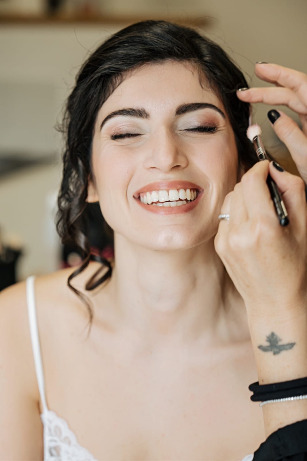 Sposa sorridente durante il trucco